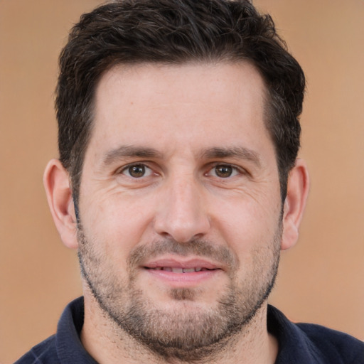 Joyful white adult male with short  brown hair and brown eyes