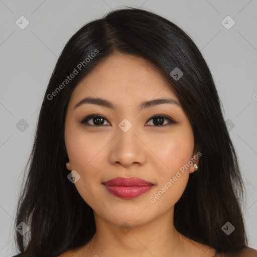 Joyful latino young-adult female with long  black hair and brown eyes