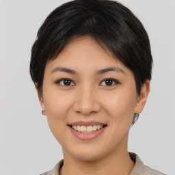 Joyful asian young-adult female with short  brown hair and brown eyes