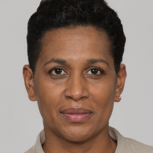 Joyful black adult female with short  black hair and brown eyes