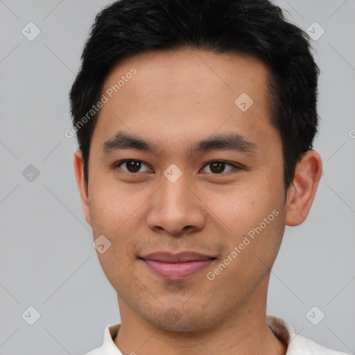 Joyful asian young-adult male with short  black hair and brown eyes