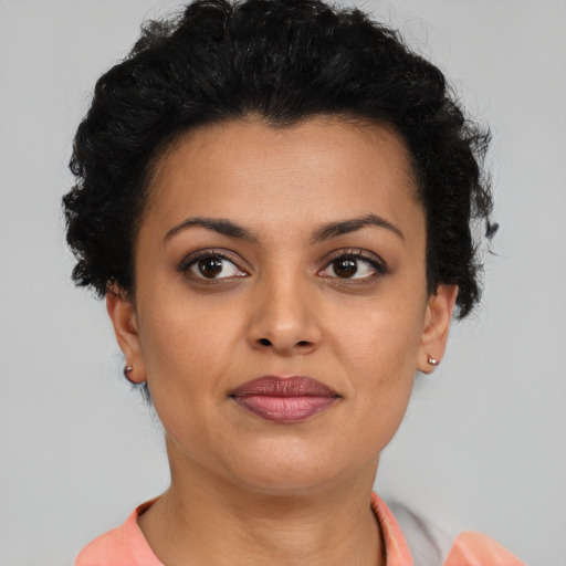 Joyful latino young-adult female with short  brown hair and brown eyes