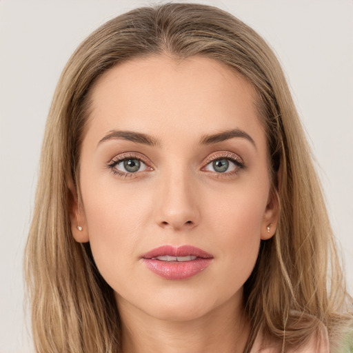 Joyful white young-adult female with long  brown hair and blue eyes