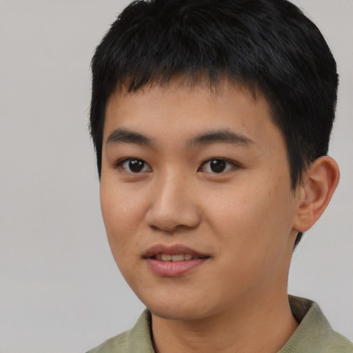 Joyful asian young-adult male with short  black hair and brown eyes