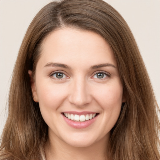 Joyful white young-adult female with long  brown hair and grey eyes