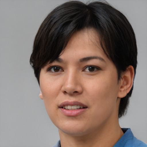Joyful asian young-adult female with short  brown hair and brown eyes