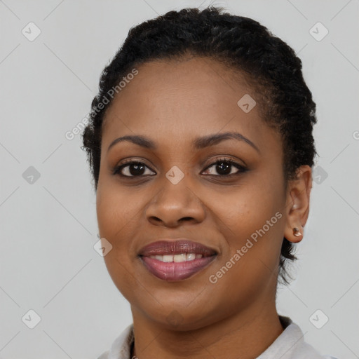 Joyful black young-adult female with short  brown hair and brown eyes