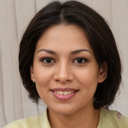 Joyful latino young-adult female with medium  brown hair and brown eyes