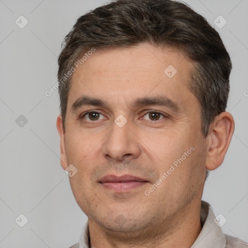 Joyful white adult male with short  brown hair and brown eyes