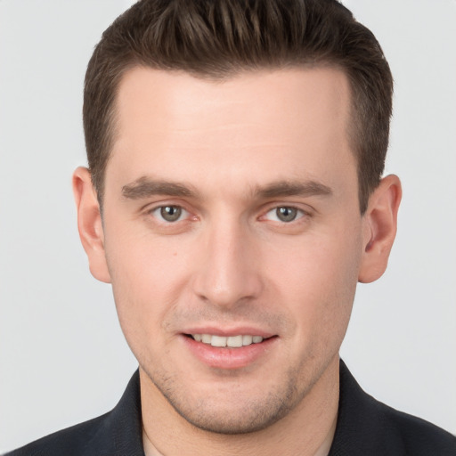 Joyful white young-adult male with short  brown hair and brown eyes