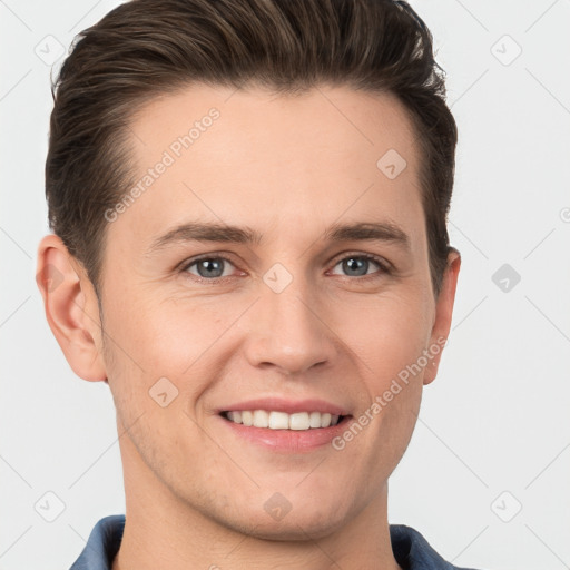 Joyful white young-adult male with short  brown hair and grey eyes