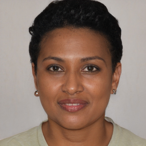 Joyful black young-adult female with short  brown hair and brown eyes