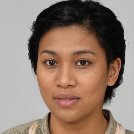 Joyful latino young-adult female with medium  brown hair and brown eyes