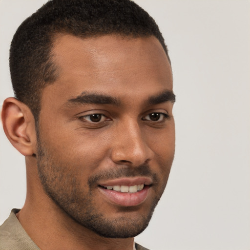 Joyful black young-adult male with short  brown hair and brown eyes