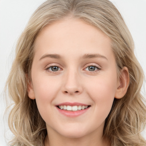 Joyful white young-adult female with long  brown hair and blue eyes