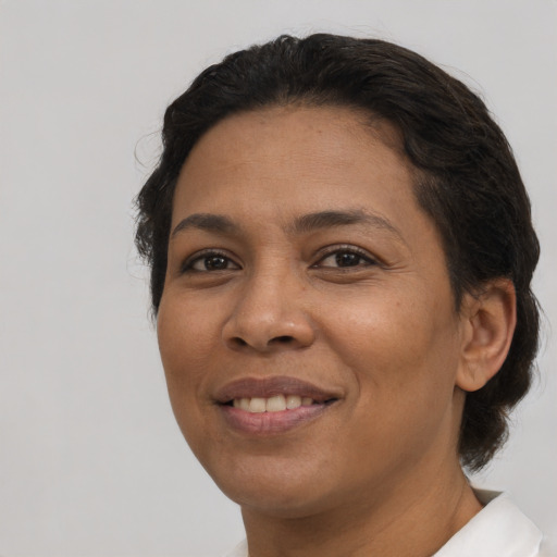 Joyful latino adult female with short  brown hair and brown eyes