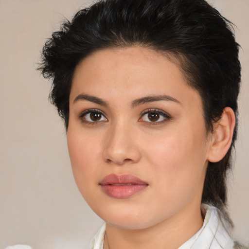 Joyful latino young-adult female with medium  brown hair and brown eyes