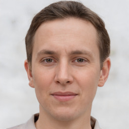 Joyful white adult male with short  brown hair and grey eyes