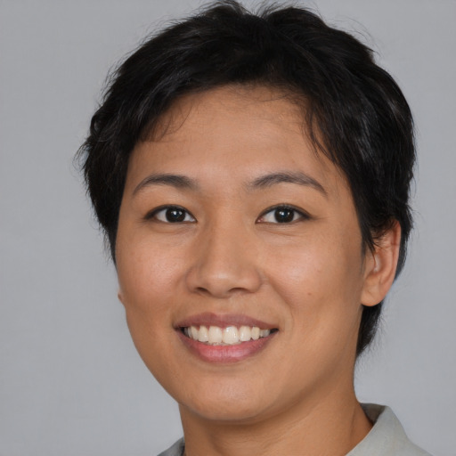 Joyful asian young-adult female with short  brown hair and brown eyes