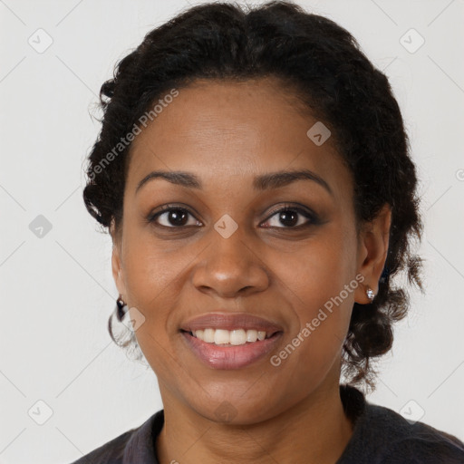 Joyful black young-adult female with long  brown hair and brown eyes