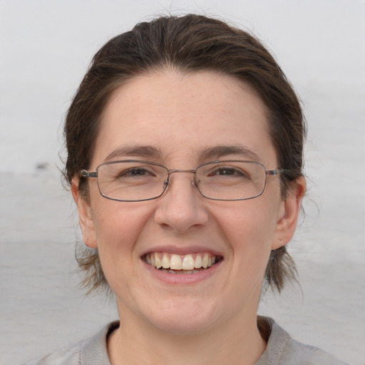 Joyful white adult female with medium  brown hair and brown eyes