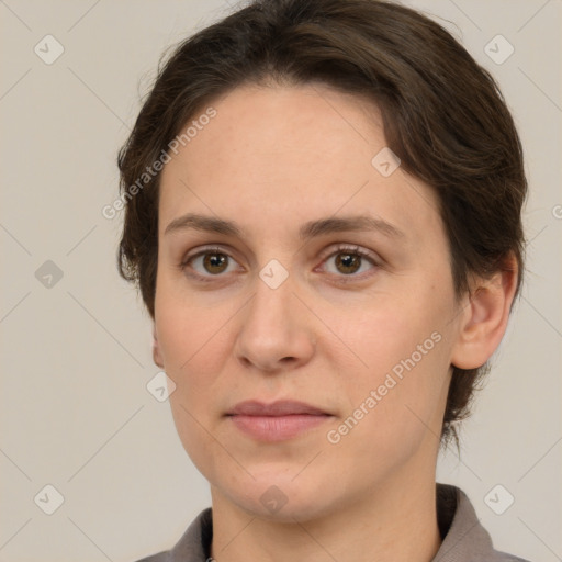 Joyful white adult female with short  brown hair and grey eyes