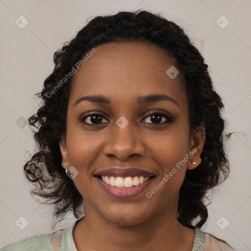 Joyful black young-adult female with medium  black hair and brown eyes