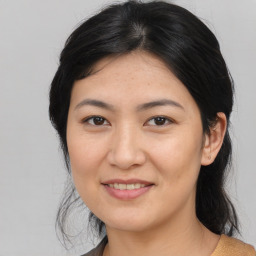 Joyful asian young-adult female with medium  black hair and brown eyes