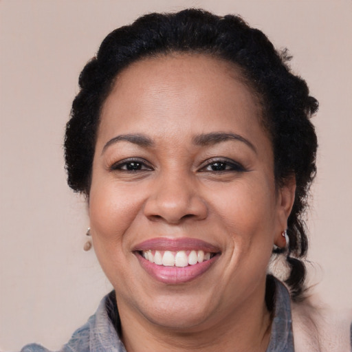 Joyful black adult female with short  brown hair and brown eyes