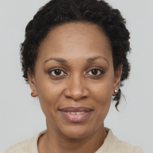 Joyful black adult female with short  brown hair and brown eyes