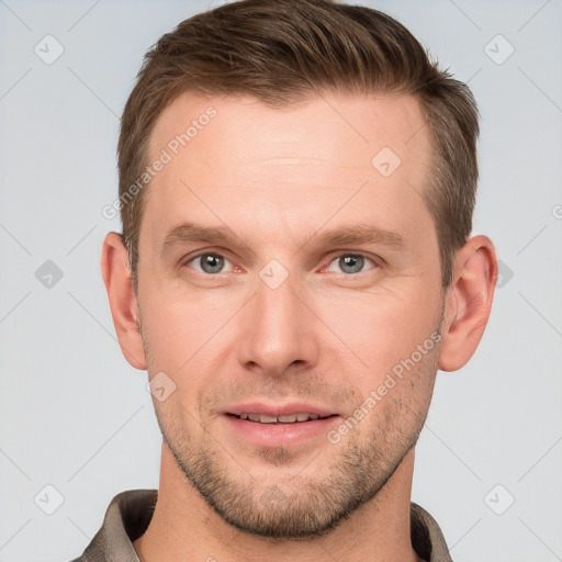 Joyful white young-adult male with short  brown hair and grey eyes