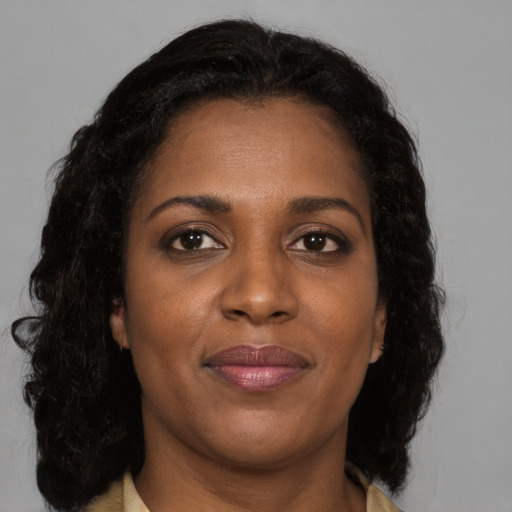 Joyful black young-adult female with medium  brown hair and brown eyes