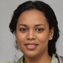 Joyful latino young-adult female with medium  brown hair and brown eyes