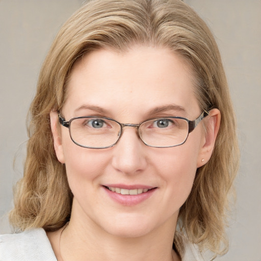 Joyful white adult female with medium  brown hair and blue eyes