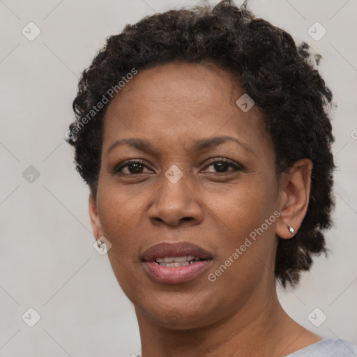 Joyful black adult female with short  brown hair and brown eyes