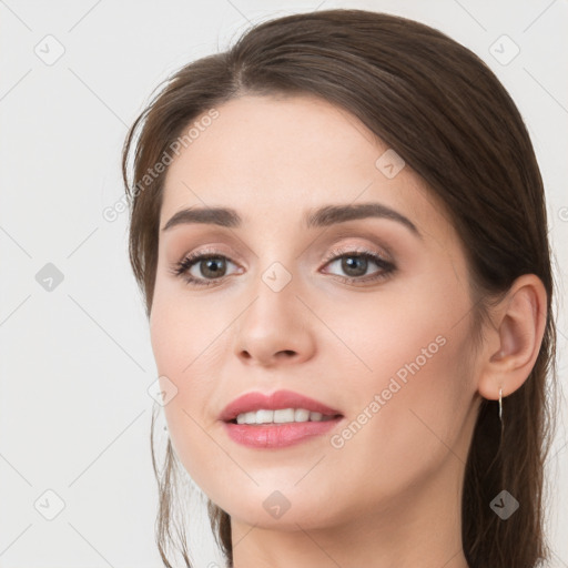 Joyful white young-adult female with long  brown hair and grey eyes