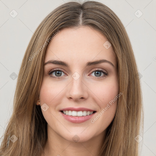 Joyful white young-adult female with long  brown hair and green eyes