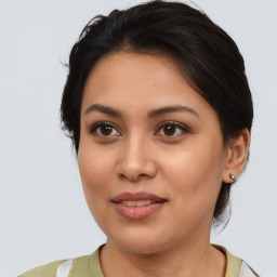 Joyful latino young-adult female with medium  brown hair and brown eyes