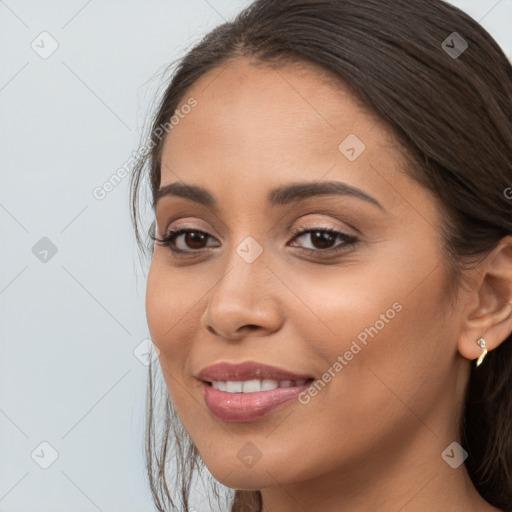 Joyful white young-adult female with long  brown hair and brown eyes