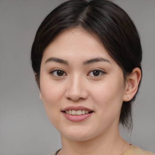 Joyful asian young-adult female with medium  brown hair and brown eyes