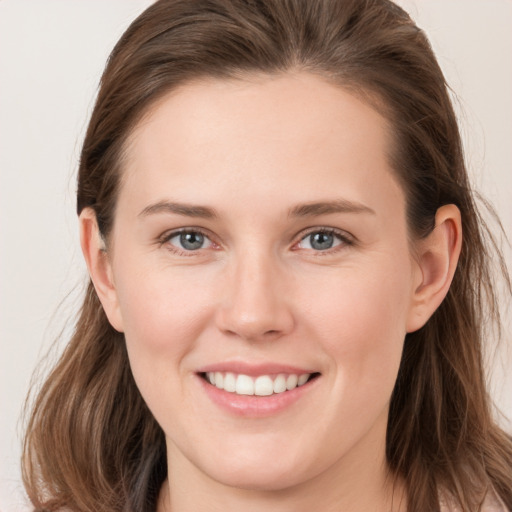 Joyful white young-adult female with long  brown hair and grey eyes