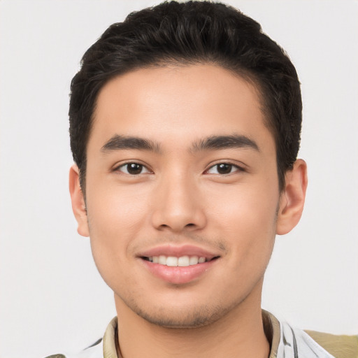 Joyful white young-adult male with short  black hair and brown eyes