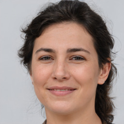 Joyful white adult female with medium  brown hair and brown eyes