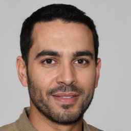 Joyful white young-adult male with short  black hair and brown eyes