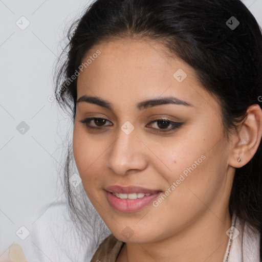 Joyful latino young-adult female with long  brown hair and brown eyes