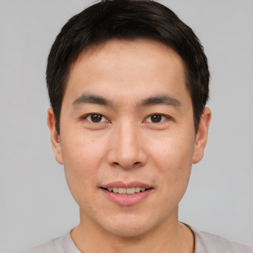 Joyful white young-adult male with short  brown hair and brown eyes