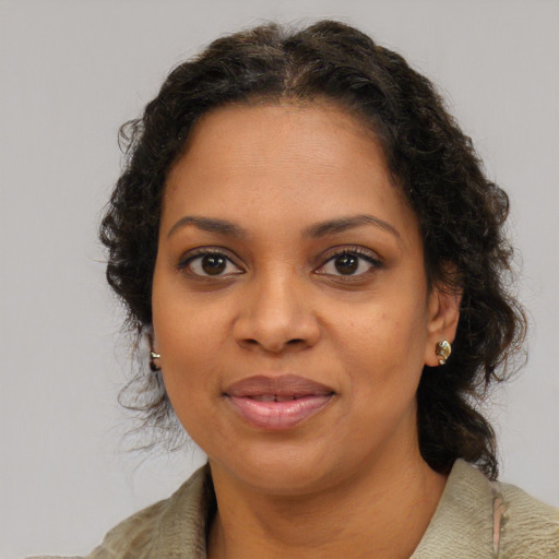Joyful black young-adult female with medium  brown hair and brown eyes