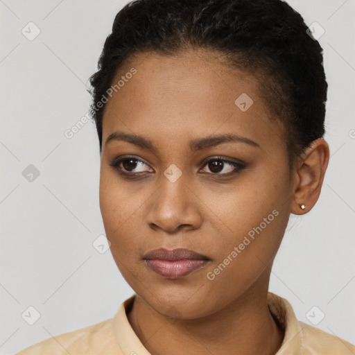 Joyful black young-adult female with short  black hair and brown eyes