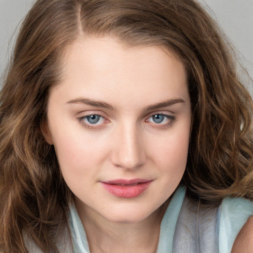 Joyful white young-adult female with long  brown hair and blue eyes