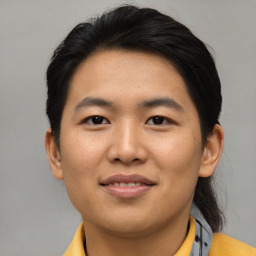 Joyful asian young-adult male with short  black hair and brown eyes